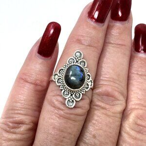 Sterling Silver ring with a dark, iridescent gemstone in a boho style band